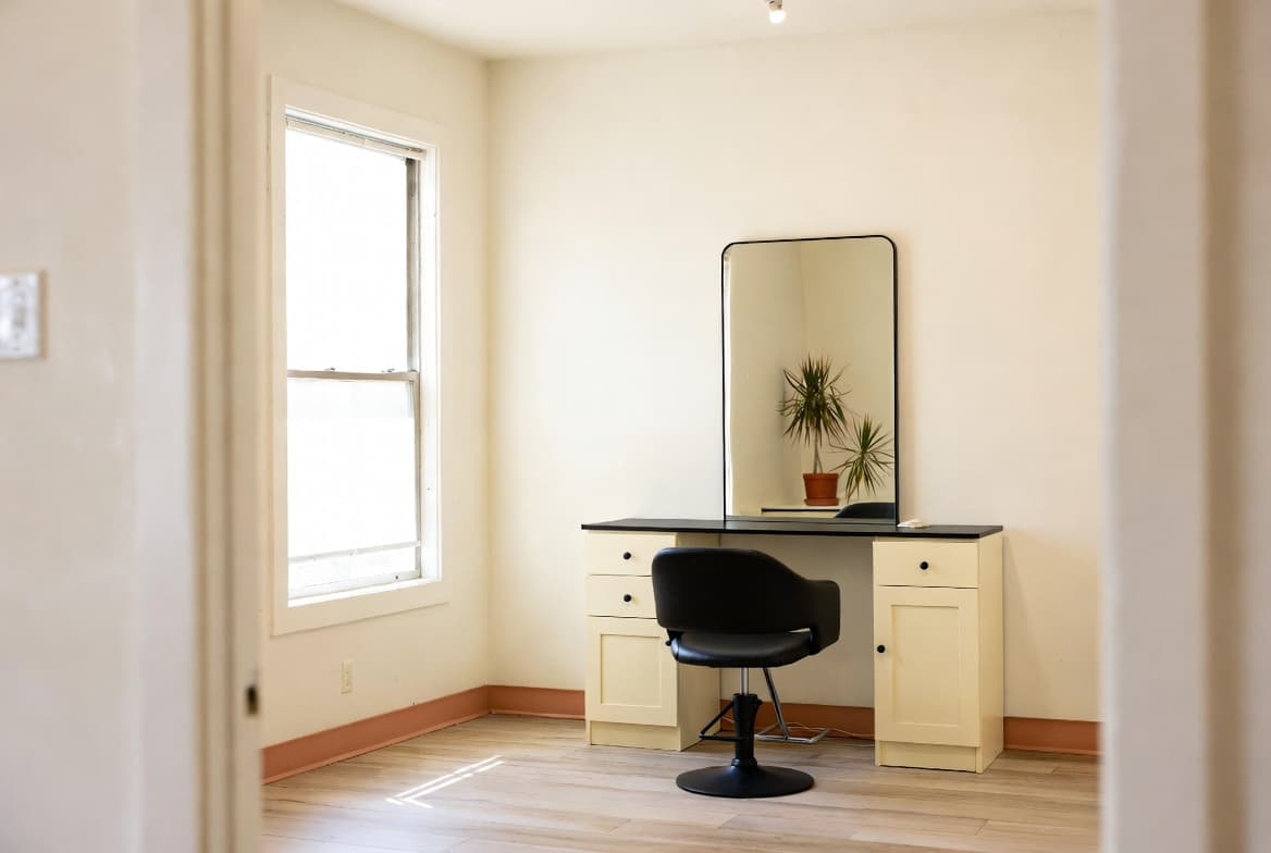 A bright, minimal salon suite with a single styling station