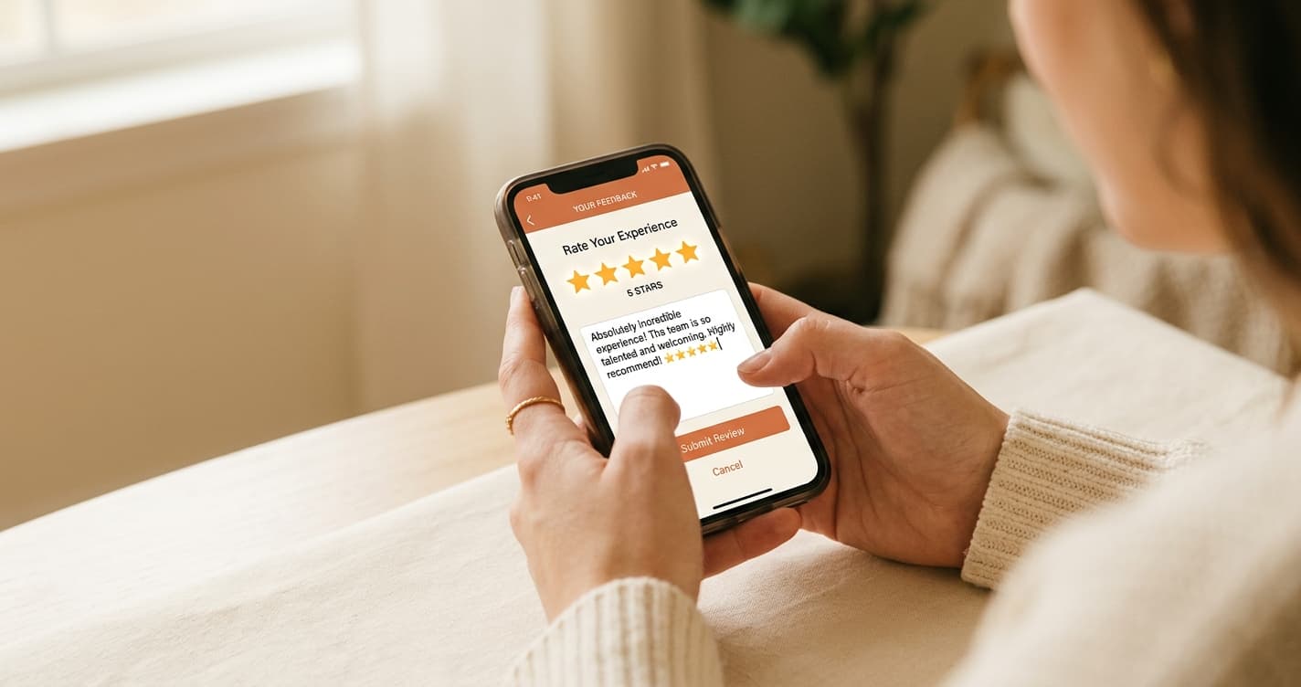 A phone showing a five star review being written in warm light
