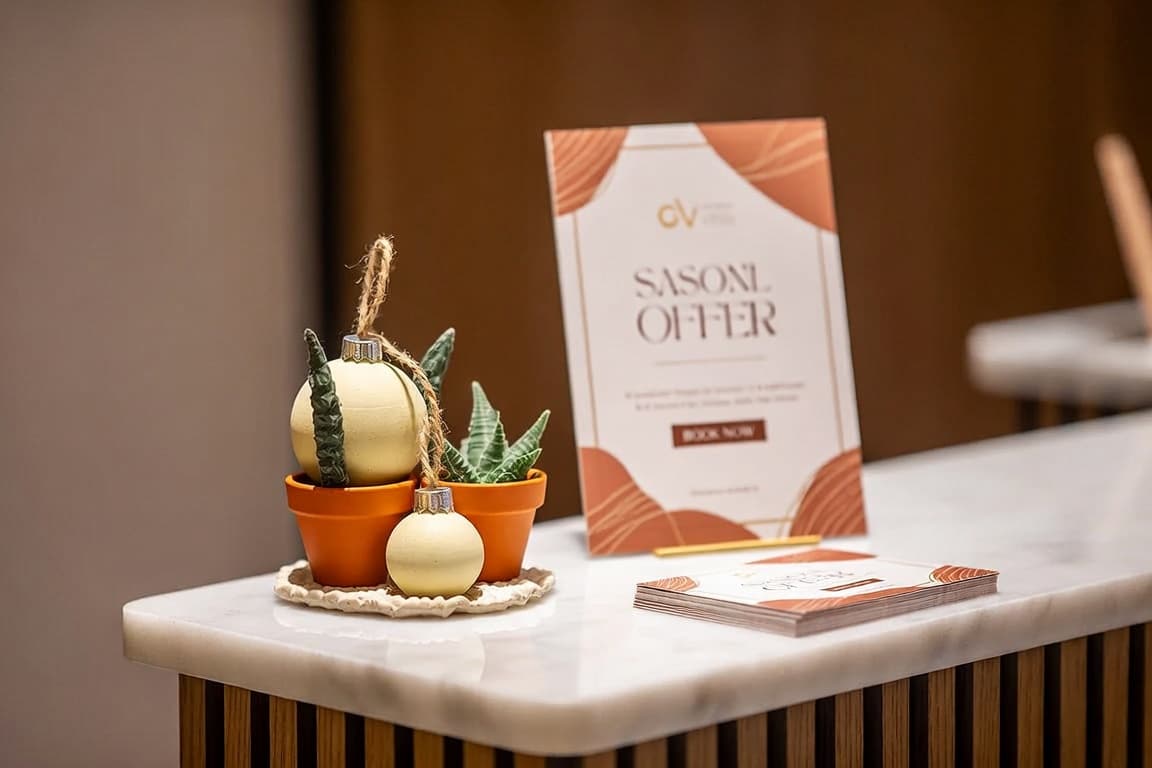 A small seasonal display and a printed offer card on a salon counter